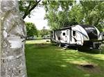 View larger image of A travel trailer in a grassy RV site at NICOLSTON DAM CAMPGROUND  TRAVELLERS PARK image #4