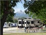 A row of RV sites with trees at SLEEPING UTE RV PARK - thumbnail