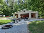 Fire pit, picnic tables and pavilion at HIDDEN PARADISE CAMPGROUND - thumbnail