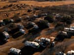 Aerial view of campground lots with RVs - thumbnail