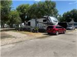 A red car near a fifth wheel trailer - thumbnail