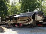 View larger image of Trailer parked in a gravel site with trees at YONAH MOUNTAIN CAMPGROUND image #1