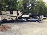A row of RVs in gravel sites at YONAH MOUNTAIN CAMPGROUND - thumbnail