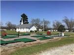 View larger image of The mini golf course with a church in the background at SOUTHERN TRAILS RV RESORT image #10