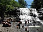 A group of people at a waterfall at BRECKENRIDGE LAKE RESORT - thumbnail