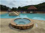 View larger image of The hot tub and swimming pool at SUMMIT VACATION  RV RESORT image #7