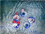 View larger image of An aerial view of people on innertubes on the river at SUMMIT VACATION  RV RESORT image #8