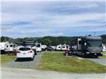 A motorhome parked in a gravel site at OLD MILL RV RESORT - thumbnail