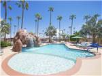 View larger image of The pool with a waterfall at PALM GARDENS MHC  RV PARK image #1