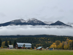 A barn and view of mountains at Golden Riverfront Campground - thumbnail