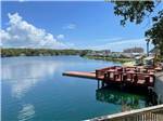 Seating area and dock at the shore at Myrtle Beach Campgrounds - thumbnail