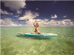 A lady doing exercise on a paddle board in the water at BIG PINE KEY & FLORIDA LOWER KEYS - thumbnail