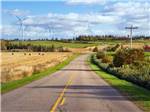A road with large energy windmill to the side at PEI PROVINCIAL PARKS - thumbnail