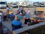 View larger image of A group of people sitting around a fire pit at COPPER MOUNTAIN RV PARK image #5