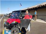 View larger image of A man in a red jacket standing next to his side by side ATV at COPPER MOUNTAIN RV PARK image #7