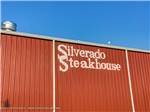 Red building with Silverado Steakhouse painted on the side at TULSA RV RANCH - thumbnail