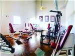 Exercise room with several weight machines at TULSA RV RANCH - thumbnail