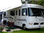 A motorhome parked in a site at WHISPERING PINES - thumbnail