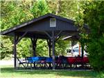 Tables and chairs under the pavilion at BLOWING SPRINGS RV PARK - thumbnail