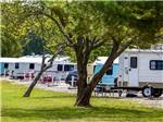 A row of trailers parked in gravel sites at BLOWING SPRINGS RV PARK - thumbnail