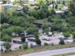 Aerial view of RV park between a river and a highway at GATEWAY RV PARK - thumbnail