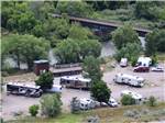 Motorhomes, travel trailers and fifth-wheels camped near river at GATEWAY RV PARK - thumbnail