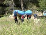 Four people carrying a raft at FRANDY PARK CAMPGROUND - thumbnail