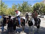 A couple of cowboys riding horses at FRANDY PARK CAMPGROUND - thumbnail