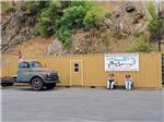 Two men statues sitting under a sign at CRYSTAL GOLD MINE & RV PARK - thumbnail