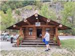 A man standing in front of the Goldmine Museum at CRYSTAL GOLD MINE & RV PARK - thumbnail