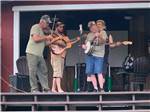 A band playing on the stage at TRIPLE CREEK CAMPGROUND - thumbnail