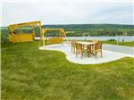 Table and chairs with swing at Bas-St-Laurent Campground - thumbnail