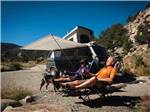 People sitting outside of their VW van - thumbnail