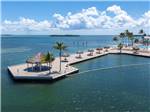 A long pier with tables leading to a gazebo - thumbnail