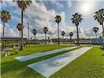The shuffleboard courts next to the pavilion at ROCKPORT RV RESORT BY RJOURNEY - thumbnail