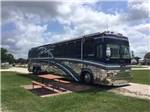 View larger image of Class A motorhome parked in a gravel site at VICTORIA COLETO LAKE RV RESORT image #7