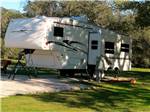 Fifth wheel trailer in a paved site at VICTORIA COLETO LAKE RV RESORT - thumbnail
