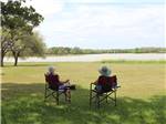 A couple of people sitting and looking at the water at BRACKENRIDGE RECREATION COMPLEX-TEXANA PARK & CAMPGROUND - thumbnail