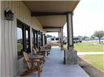Wooden chairs in front of the office at TEXAS LAKESIDE RV RESORT - thumbnail