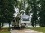 A large RV at site by the lake - thumbnail