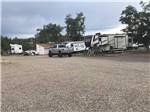 Gravel campsites with vehicles parked nearby at GRAND CANYON VIEW RV - thumbnail