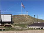 An American flag on a hill over the campsites at SHELBY RV PARK AND RESORT - thumbnail