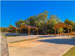 Paved RV sites, each with covered picnic table at Hidden Cove Park - thumbnail