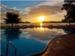 The sun reflects on the lake and pool - thumbnail