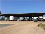 A row of covered RV parking at NORTH POINT RV PARK - thumbnail