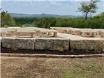 Outdoor stone bench seating at the wedding venue - thumbnail