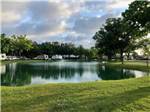 A view of the lake with a fountain at GAINESVILLE RV PARK - thumbnail