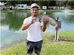 Angler holds up fish he just caught at GAINESVILLE RV PARK - thumbnail
