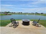 View larger image of A fire pit overlooking the lake at KATY LAKE RV RESORT image #1