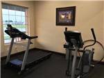 Exercise room with elliptical machine and treadmill at KATY LAKE RV RESORT - thumbnail